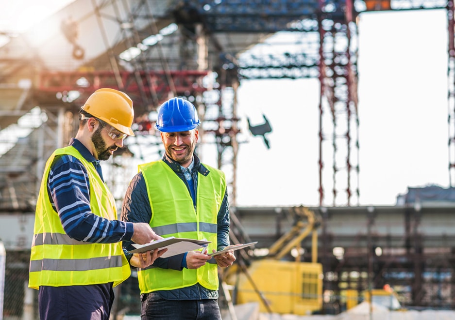 Two workers looking at clipboards