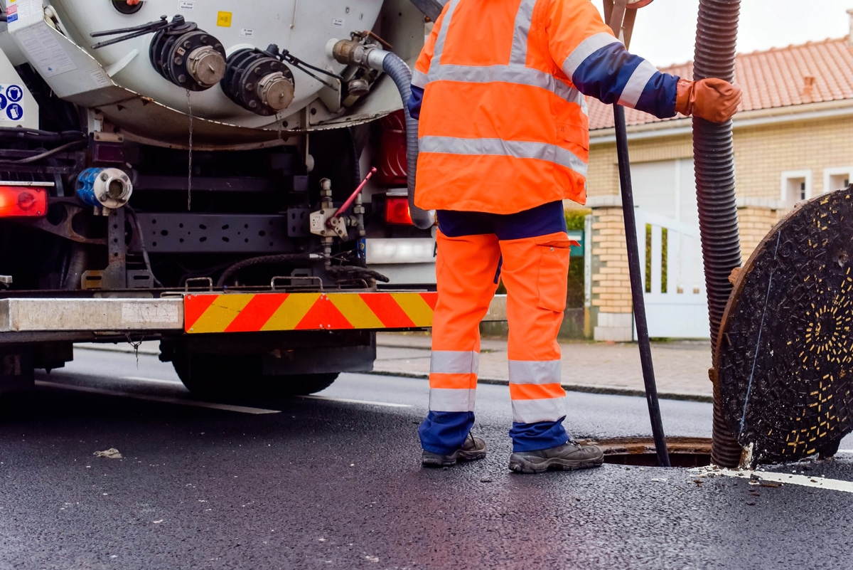 City Utility Worker Over Manhole