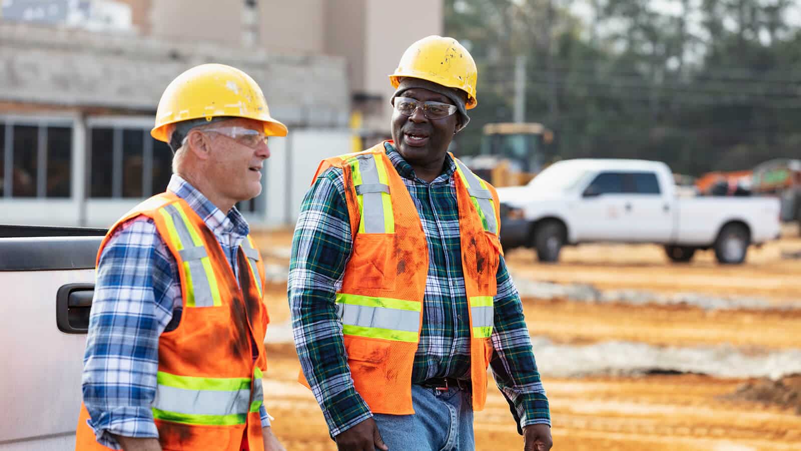 CGA employees wearing hard hats talking