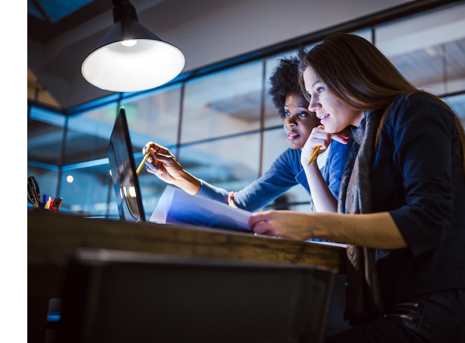 CGA employees looking at computer