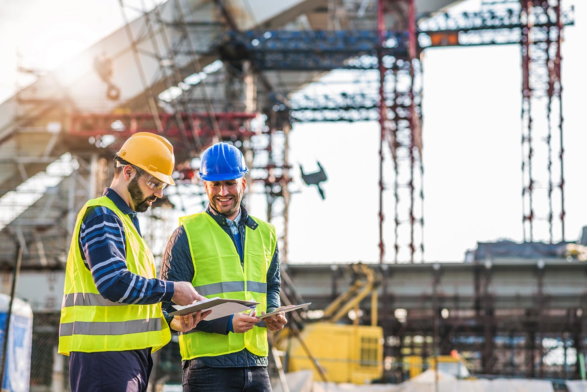Two Workers Smiling At Site