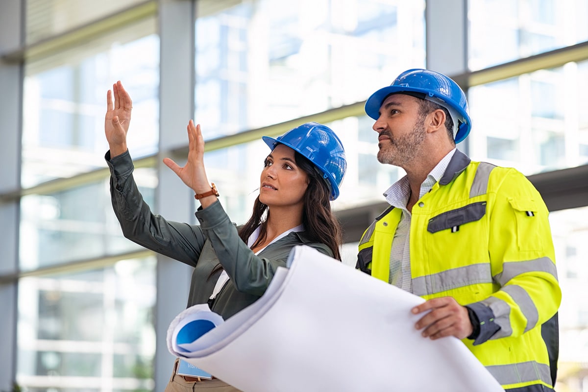 Two Workers With Blueprint